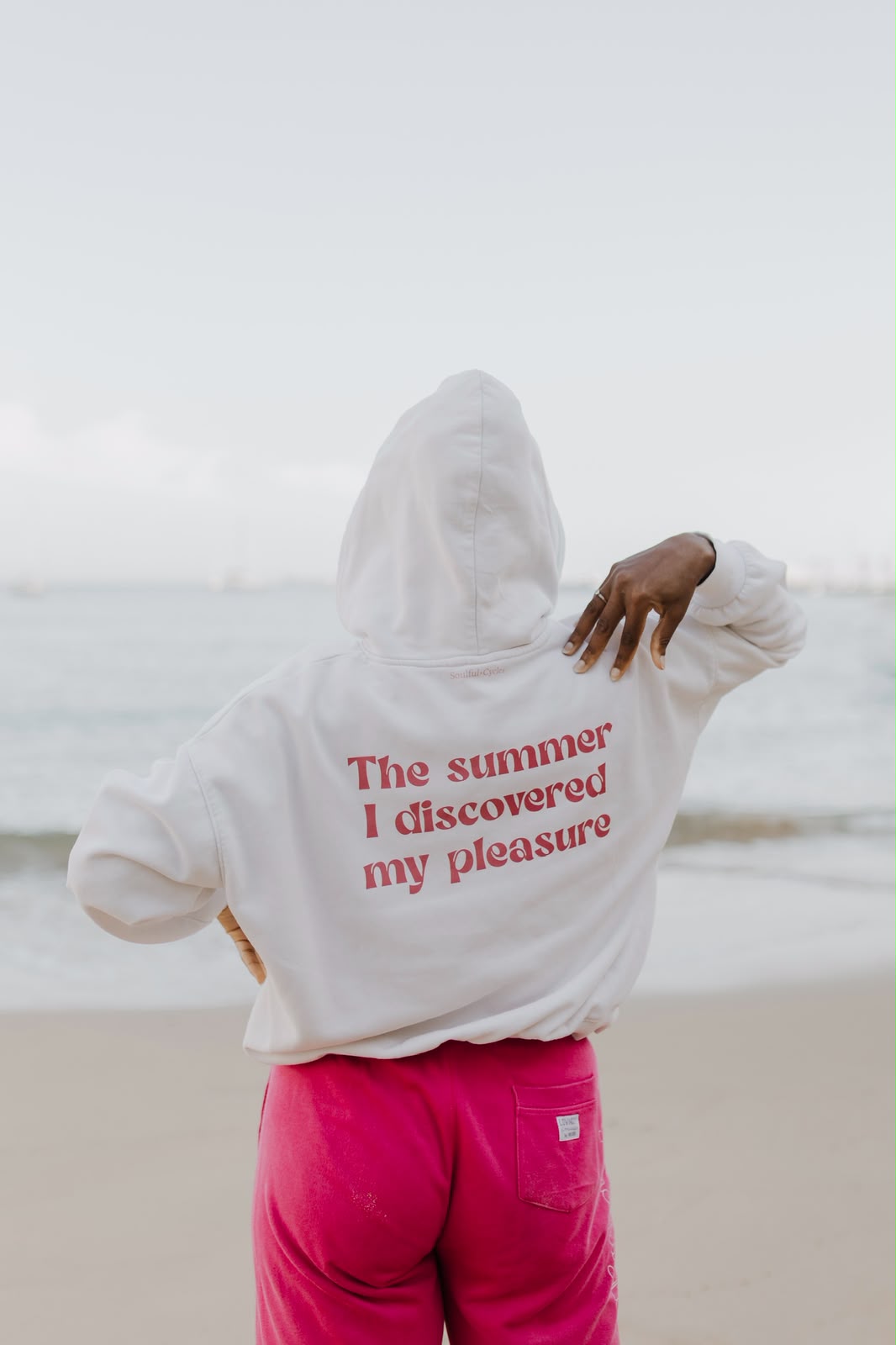 Costas de uma hoodie branca com a frase 'The summer I discovered my pleasure'